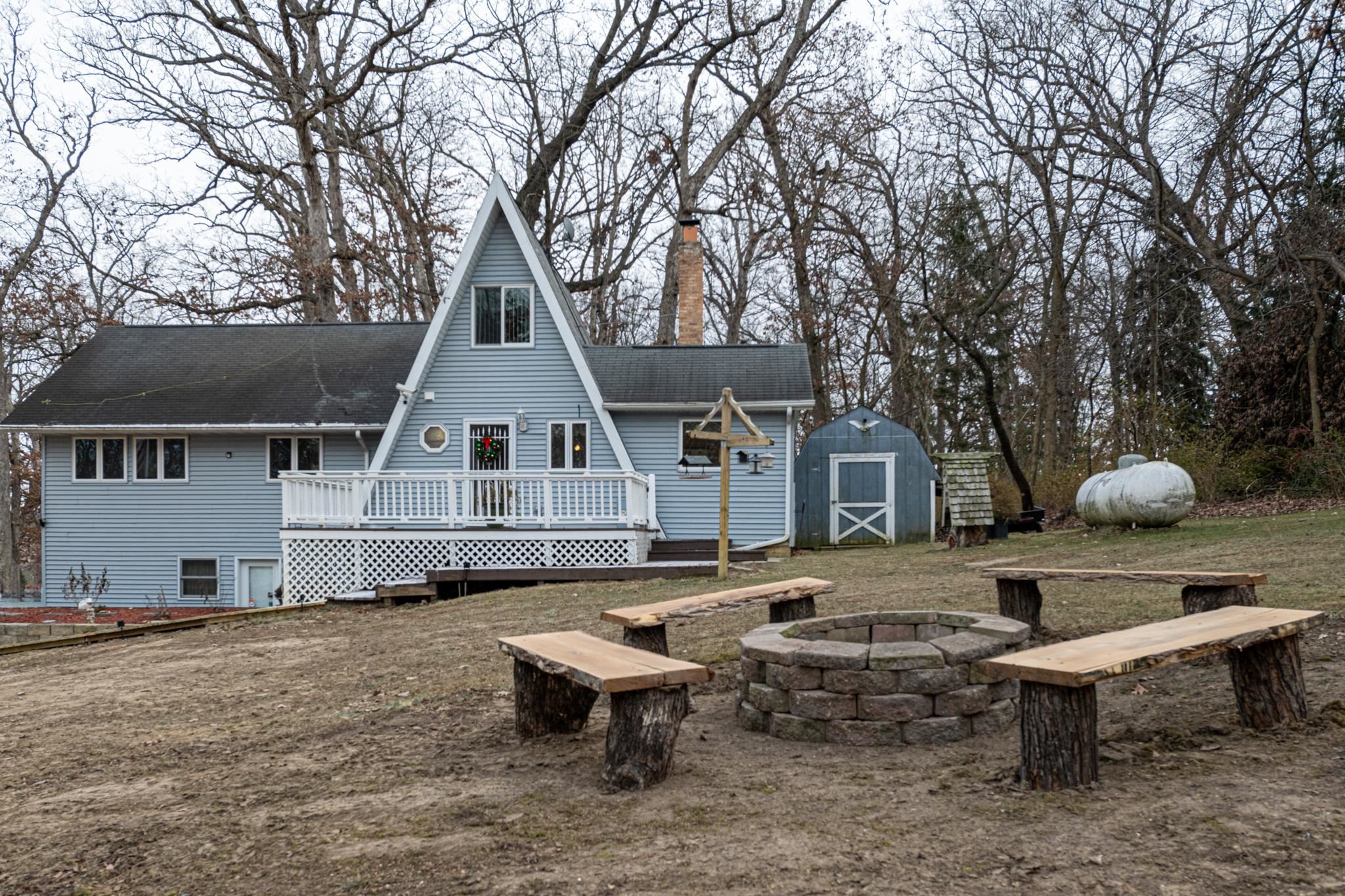 a view of a house with a chairs in a patio