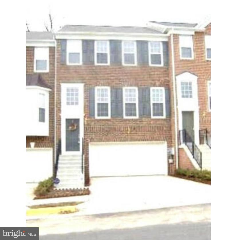 a picture of a brick house with many windows