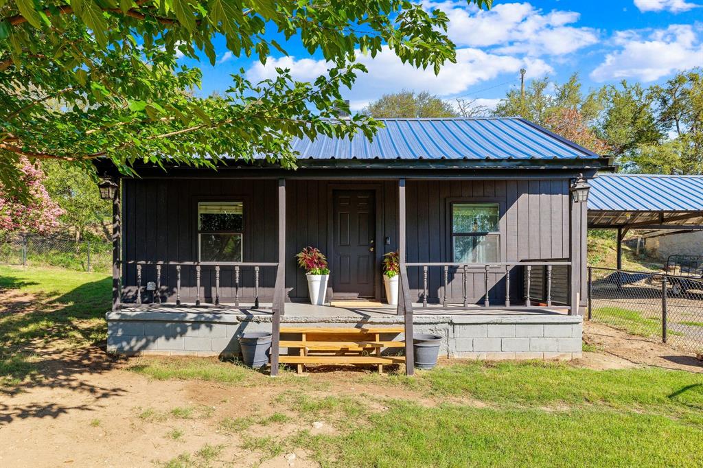 a view of a house with backyard porch and sitting area