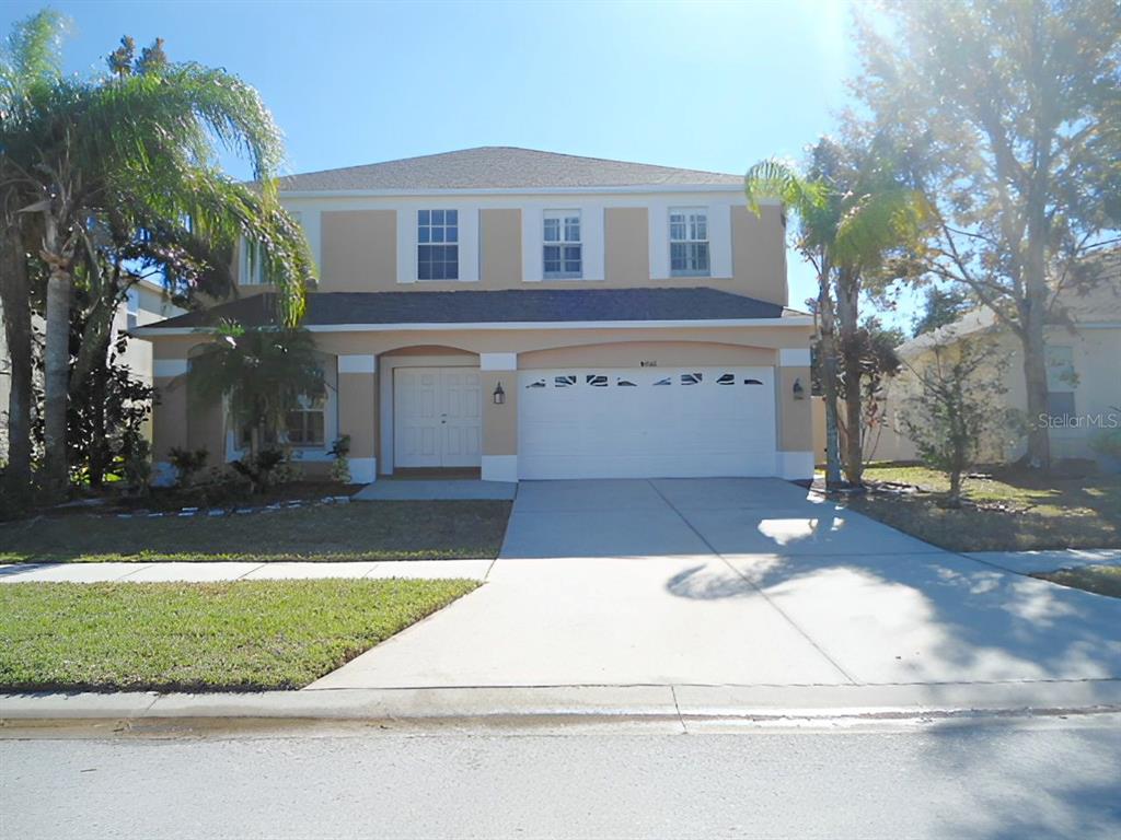 a front view of a house with a yard and garage