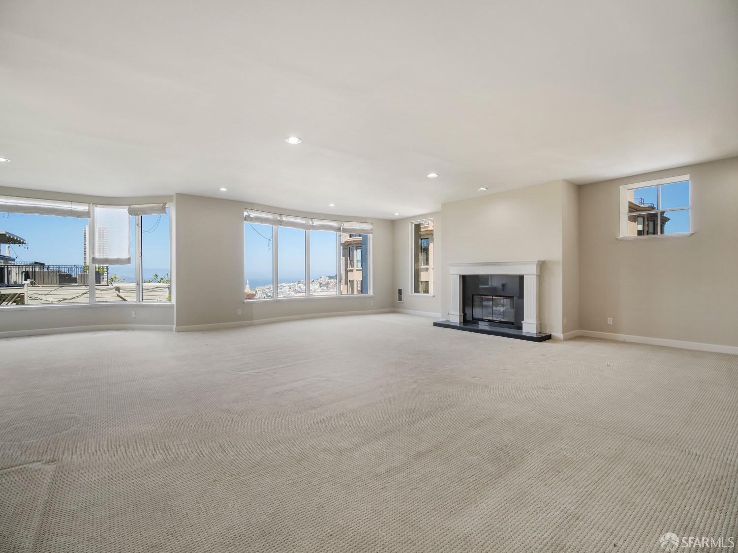 a view of an empty room with a fireplace