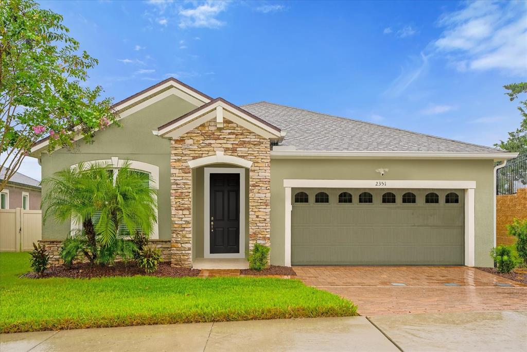 a front view of a house with a yard and garage