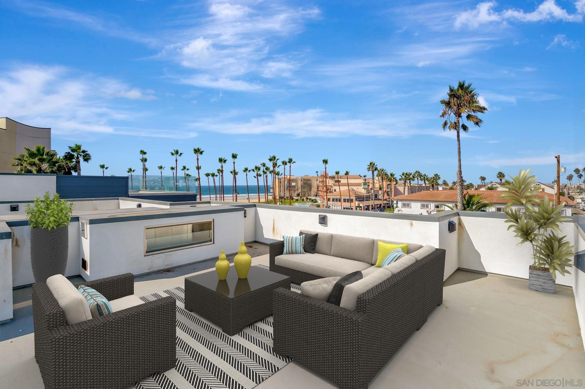 a view of a roof deck with couches and potted plants