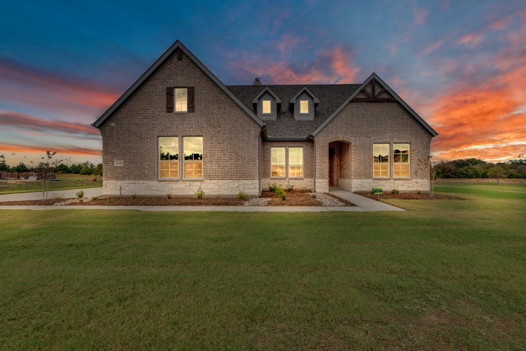 a front view of house with yard and green space