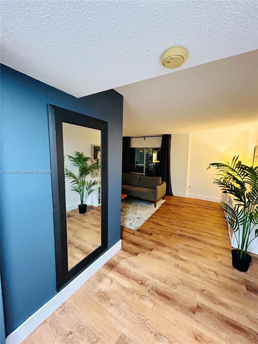 a bedroom with a bed and a potted plant