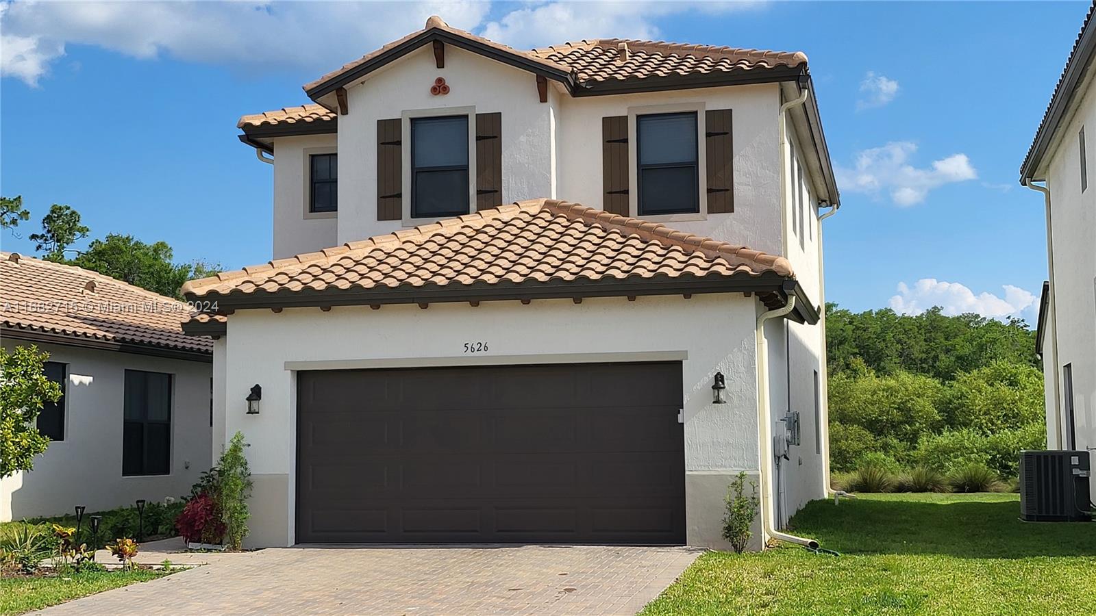 a front view of a house with a yard