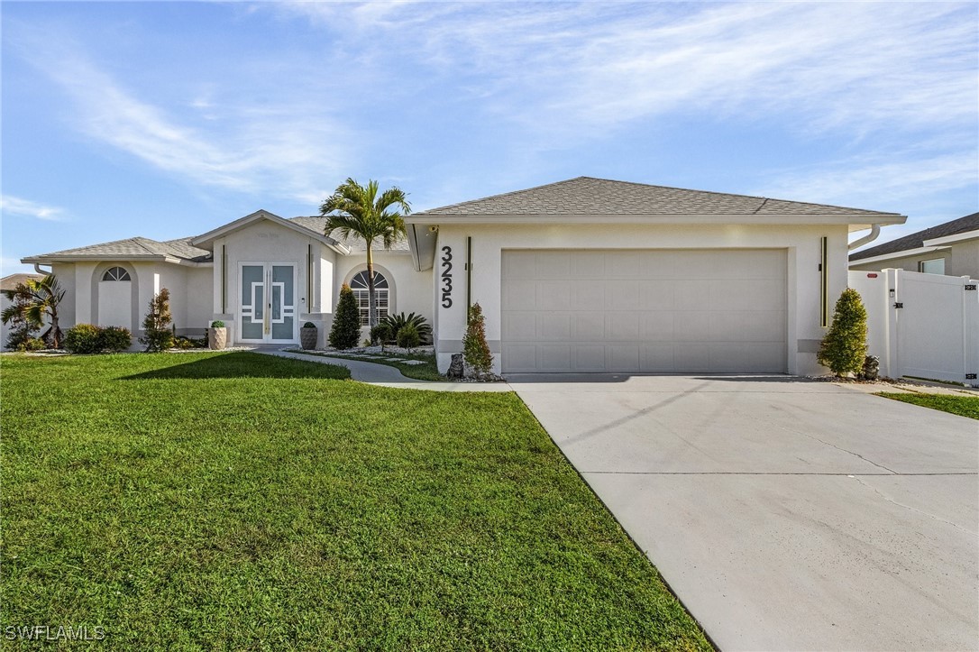 a front view of a house with a yard and garage