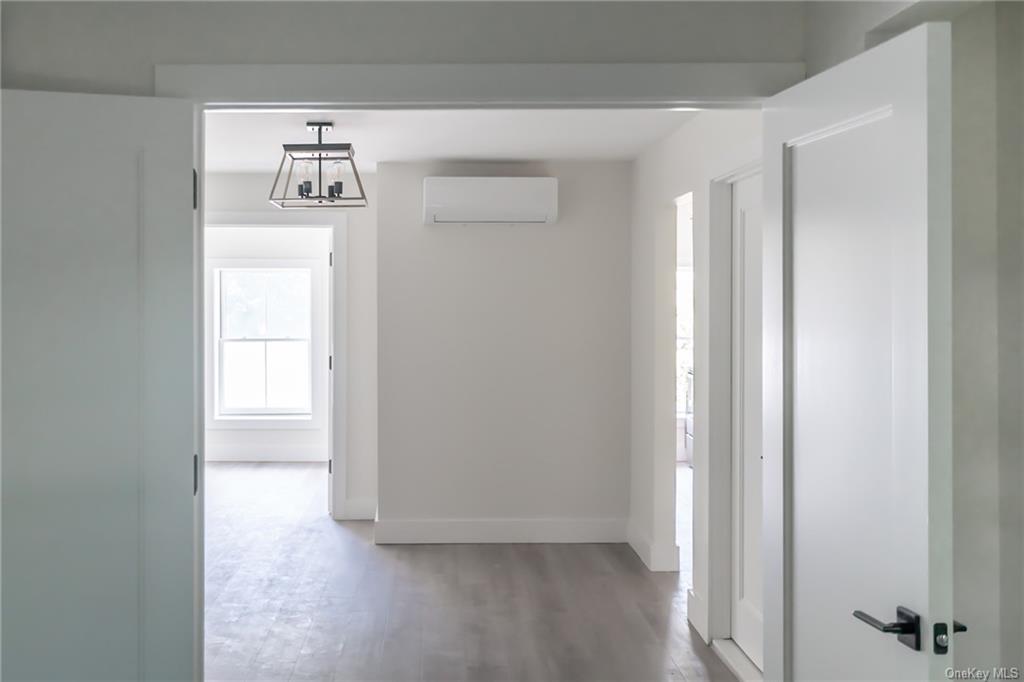 a view of hallway with wooden floor