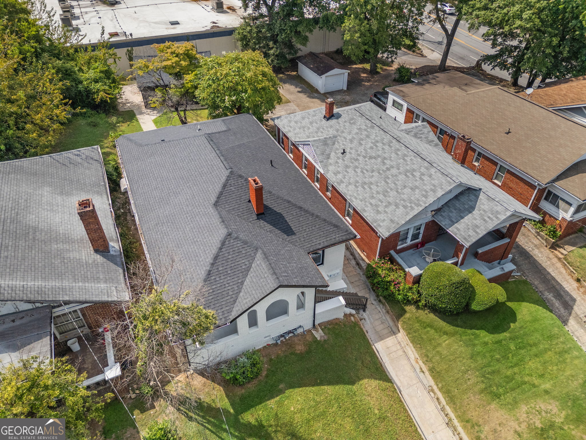 an aerial view of a house with a yard and furniture