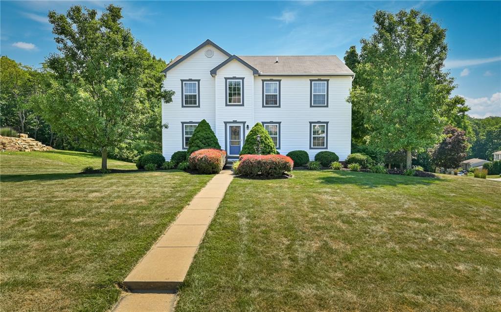 a front view of house with yard and green space