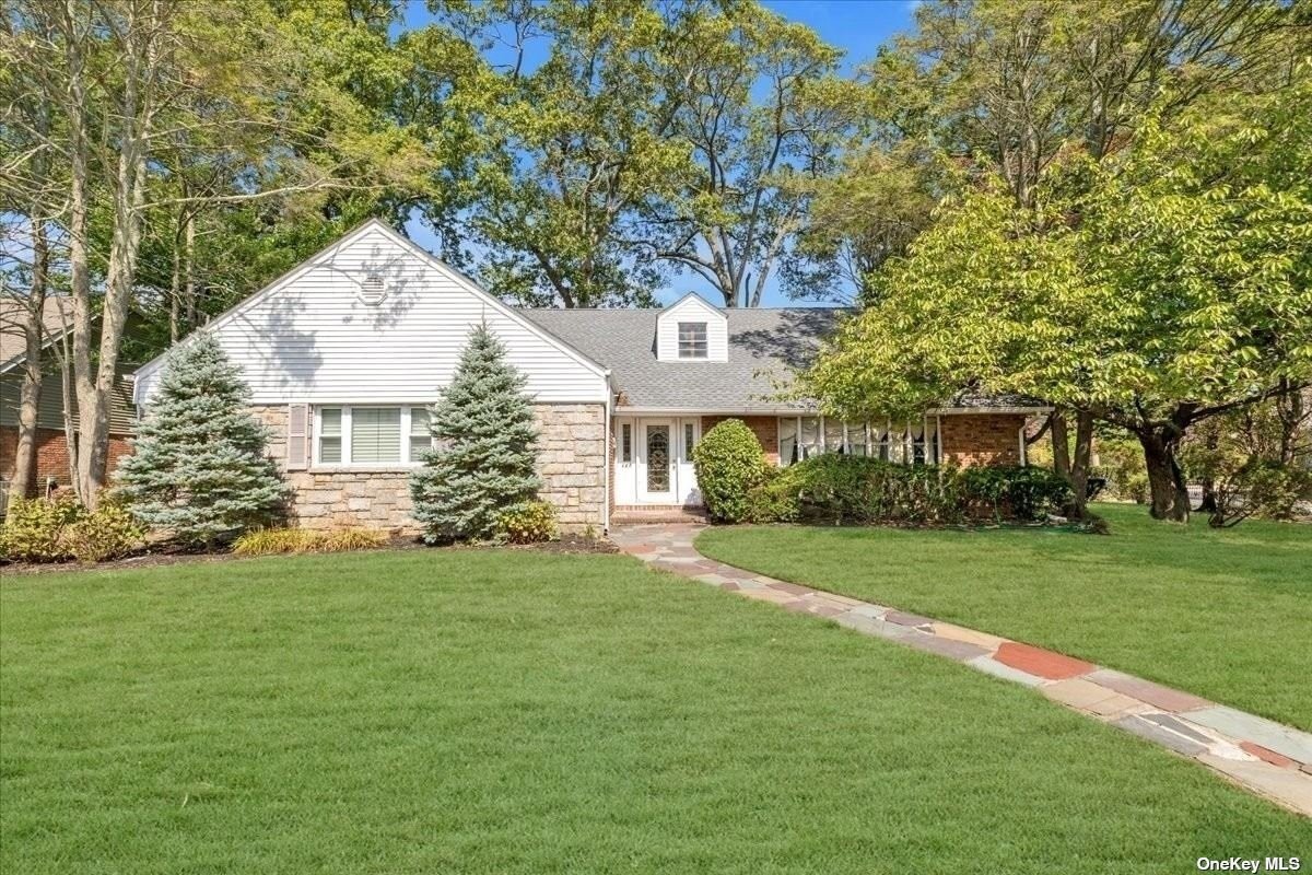 a front view of a house with a garden