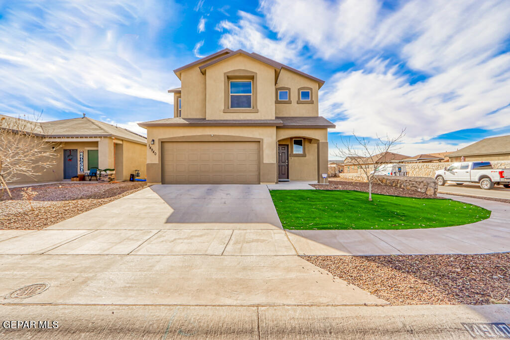 a front view of a house with a yard and garage