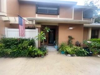 a view of a house with potted plants