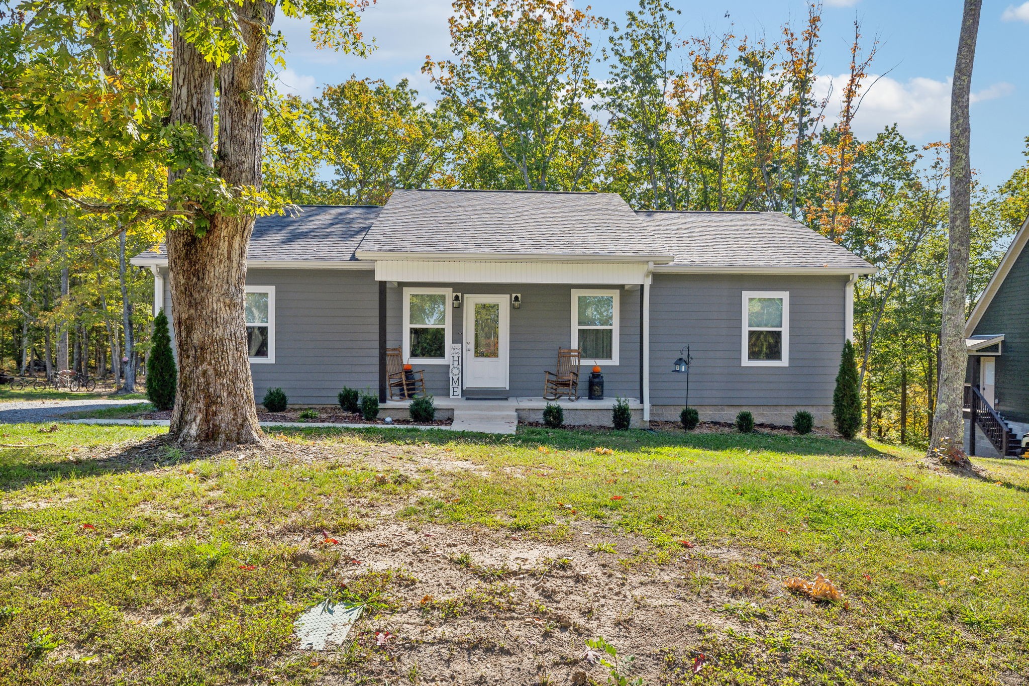 a view of a house with a yard and sitting area