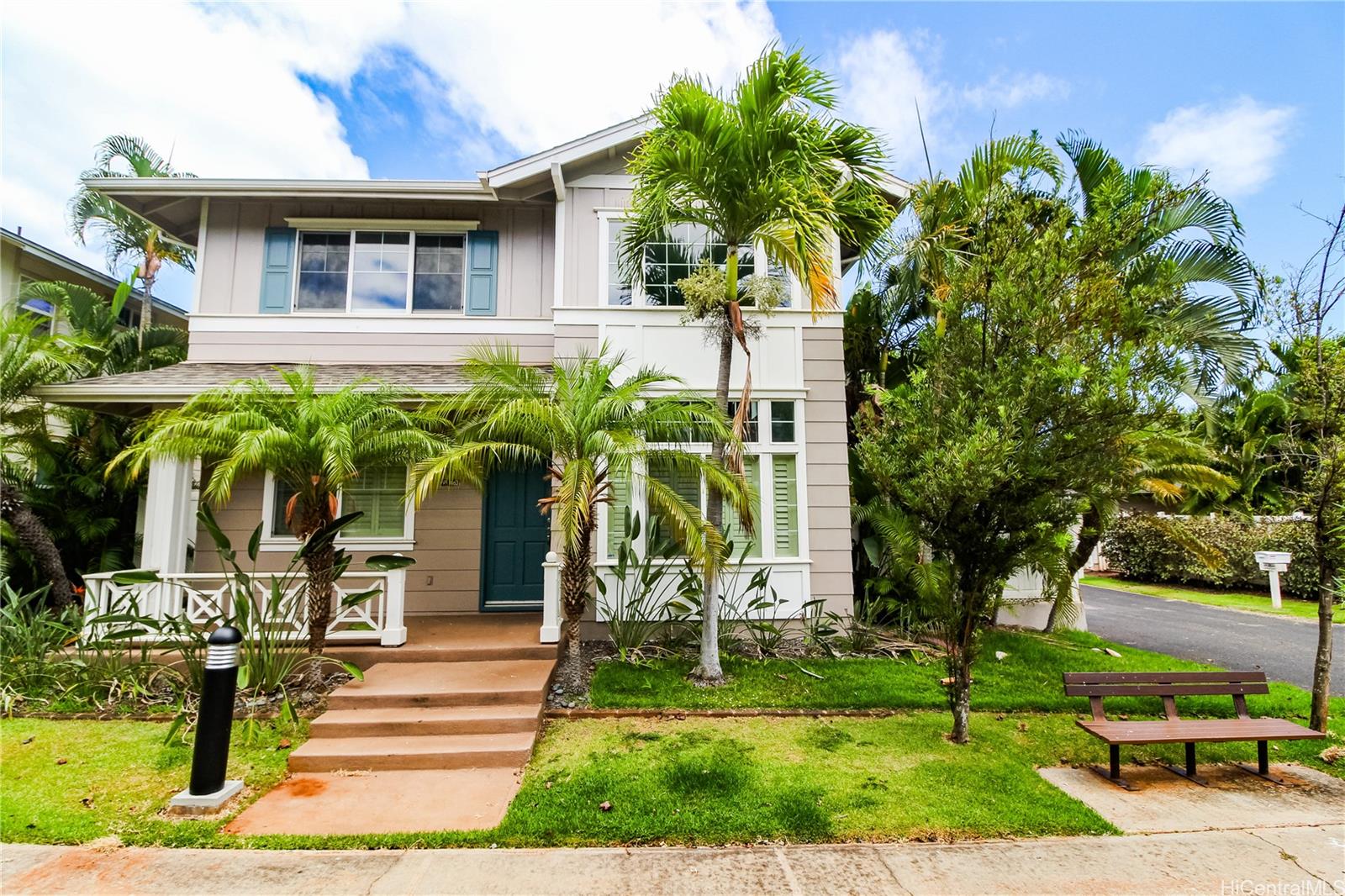 a view of house with a yard and potted plants