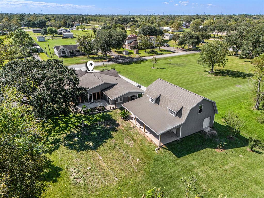 an aerial view of a house with garden space and ocean view