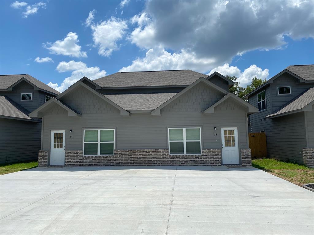 a view of a house with a yard and a garage