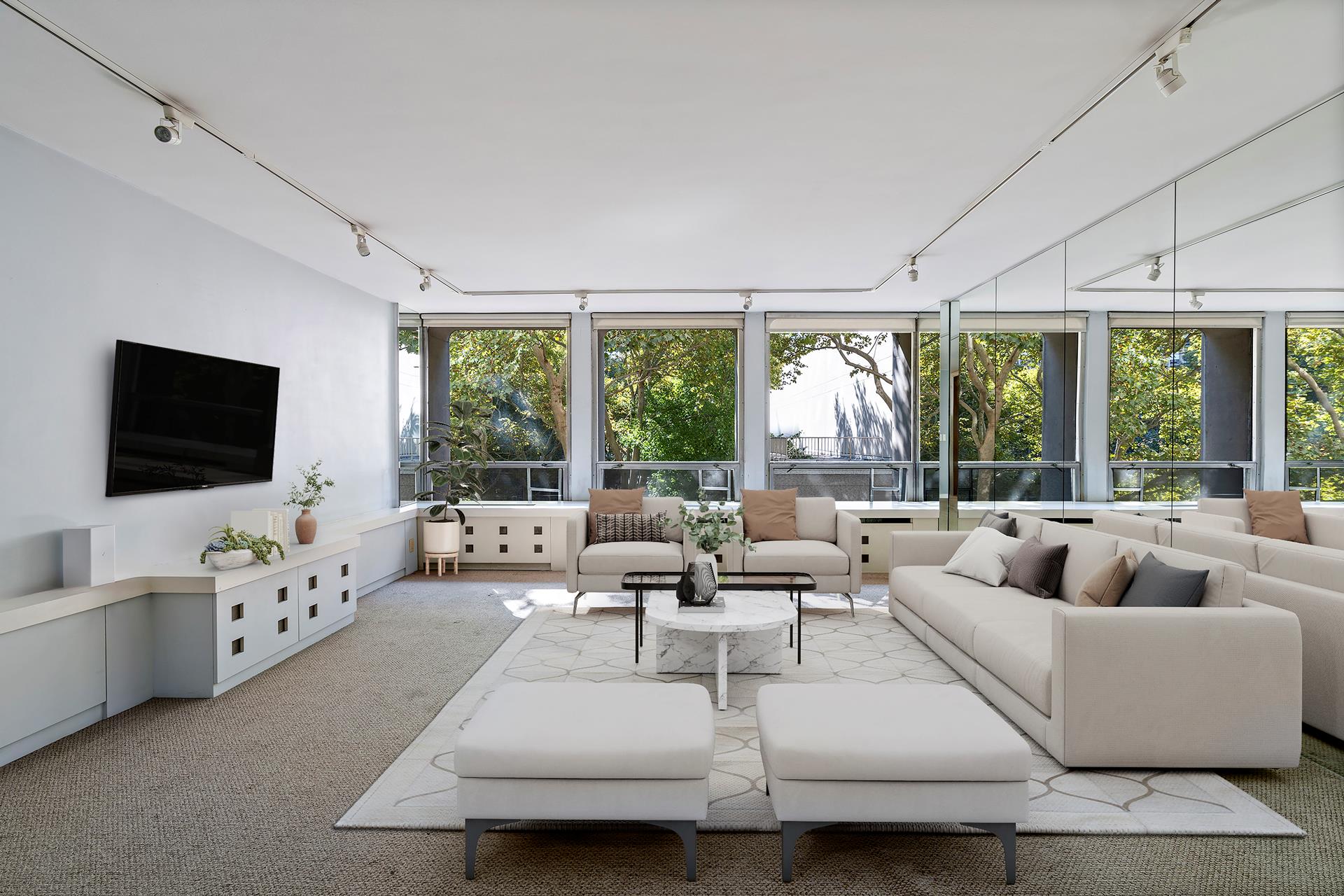 a living room with furniture large window and flat screen tv