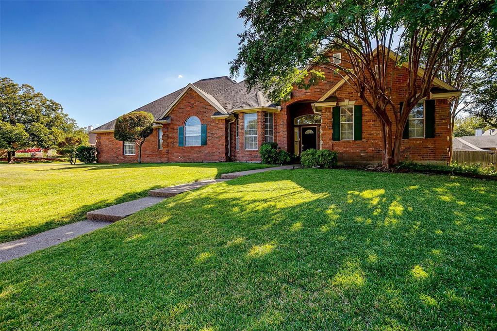 a front view of a house with yard and green space