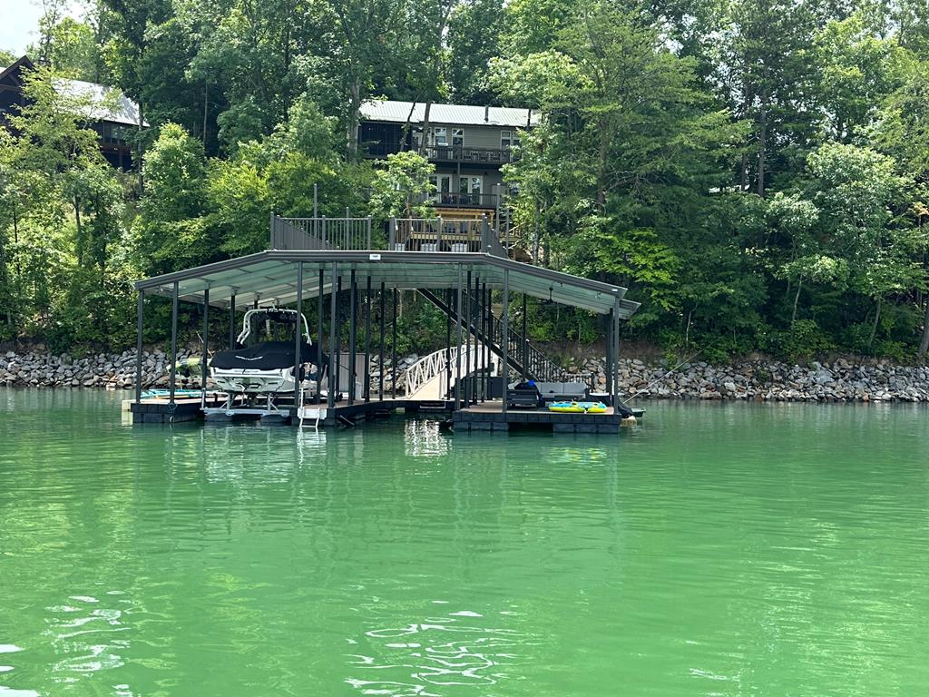 an aerial view of a house with swimming pool patio and lake view