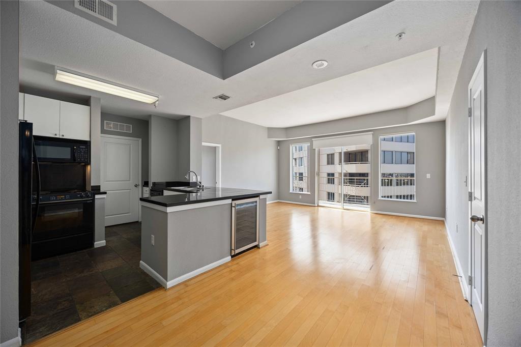 a large kitchen with a large counter top stainless steel appliances and cabinets