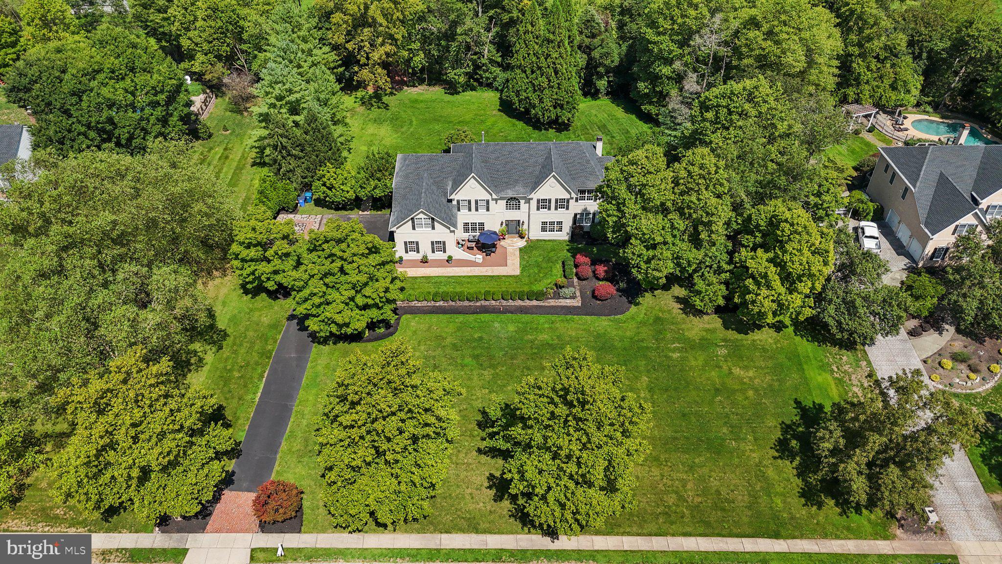 an aerial view of a house with a yard basket ball court and outdoor seating