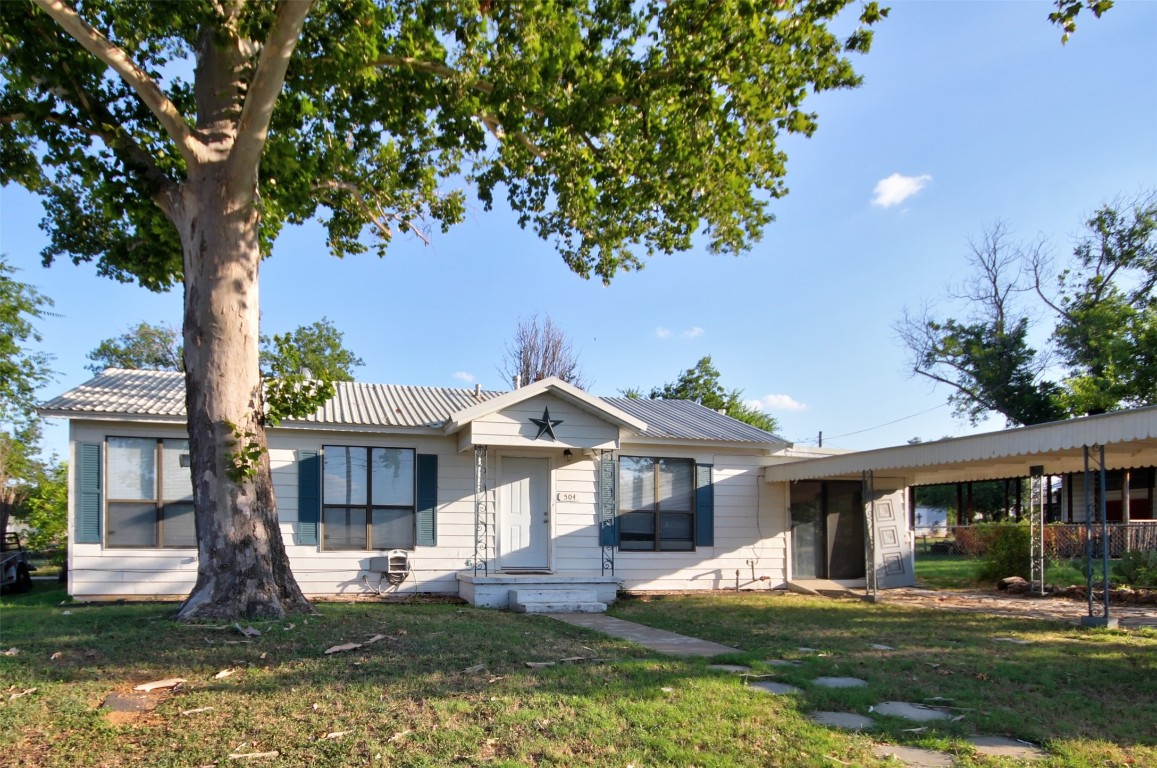 a front view of a house with a yard porch and patio