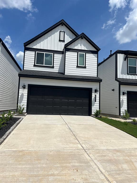 a front view of a house with yard and parking