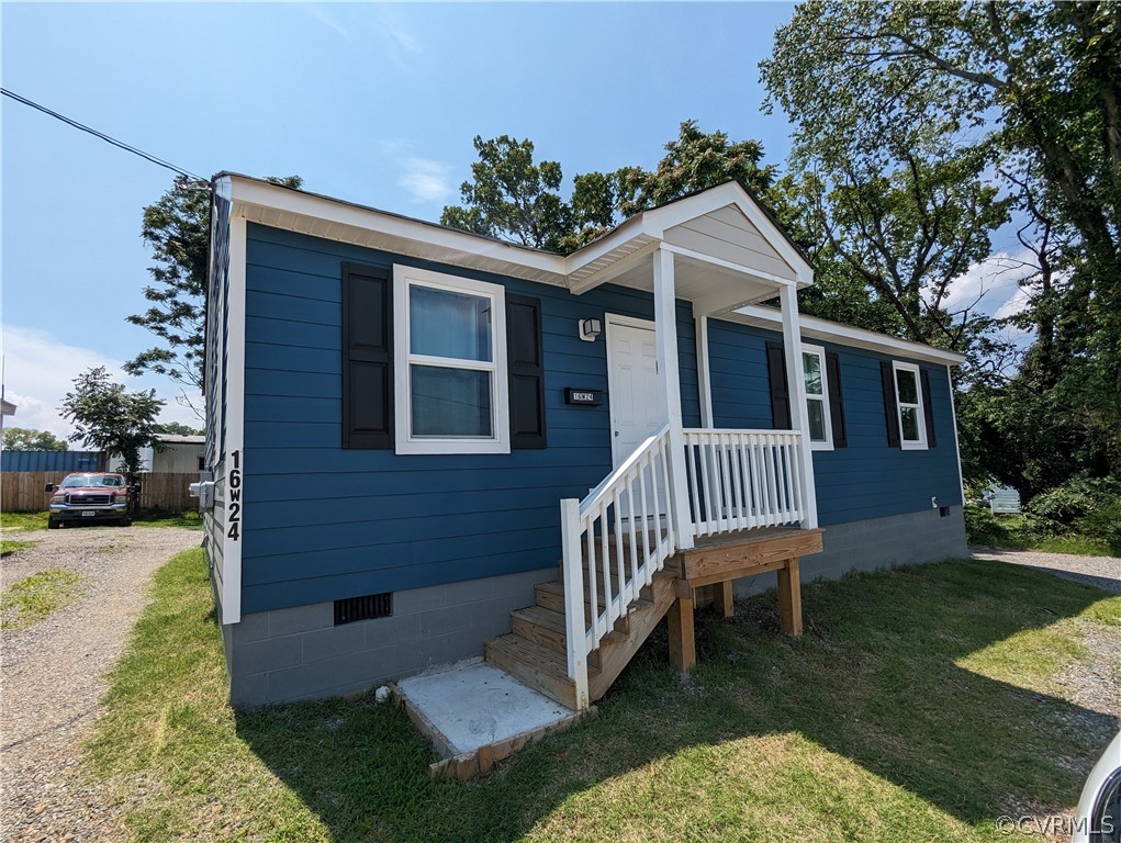 a view of a house with a yard and deck