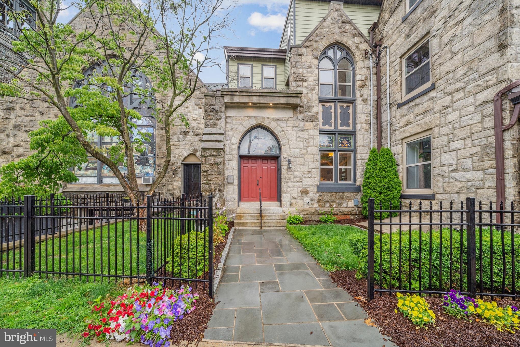 a front view of a house with a garden