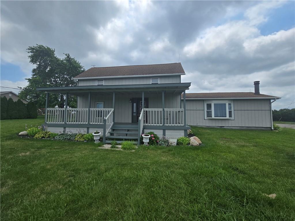 a view of an house with backyard space and garden