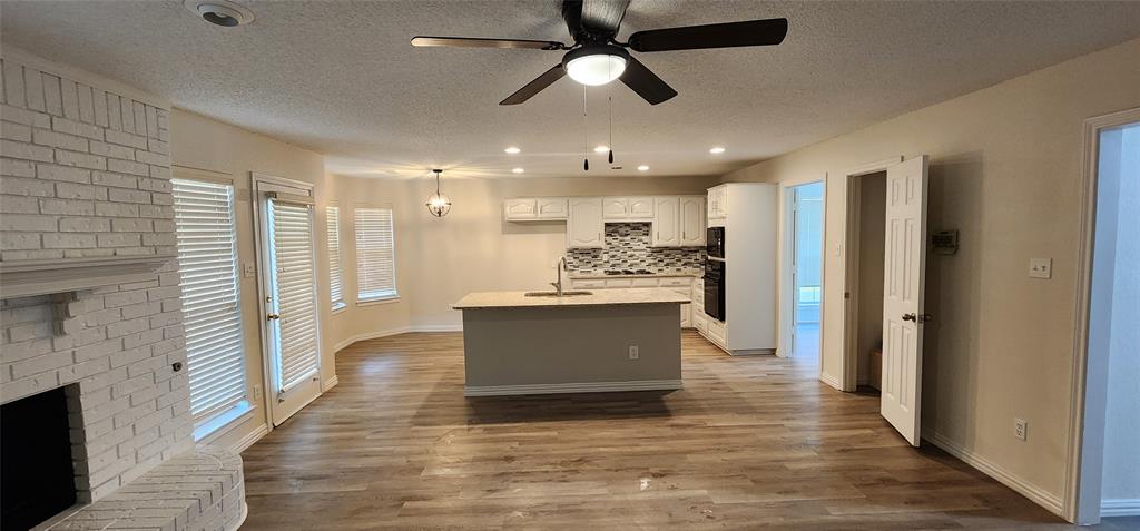 a view of kitchen with refrigerator and window