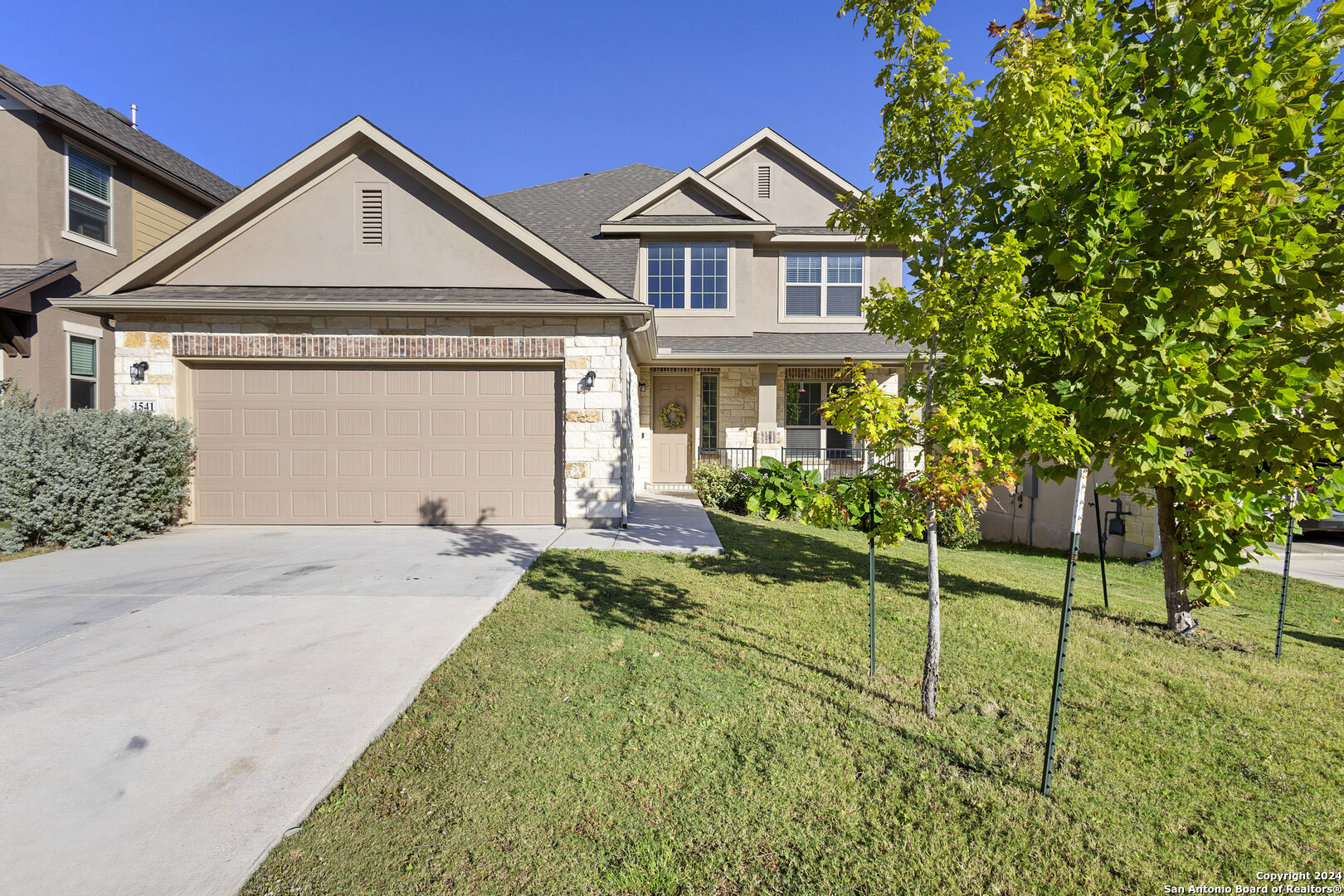 a front view of a house with a yard