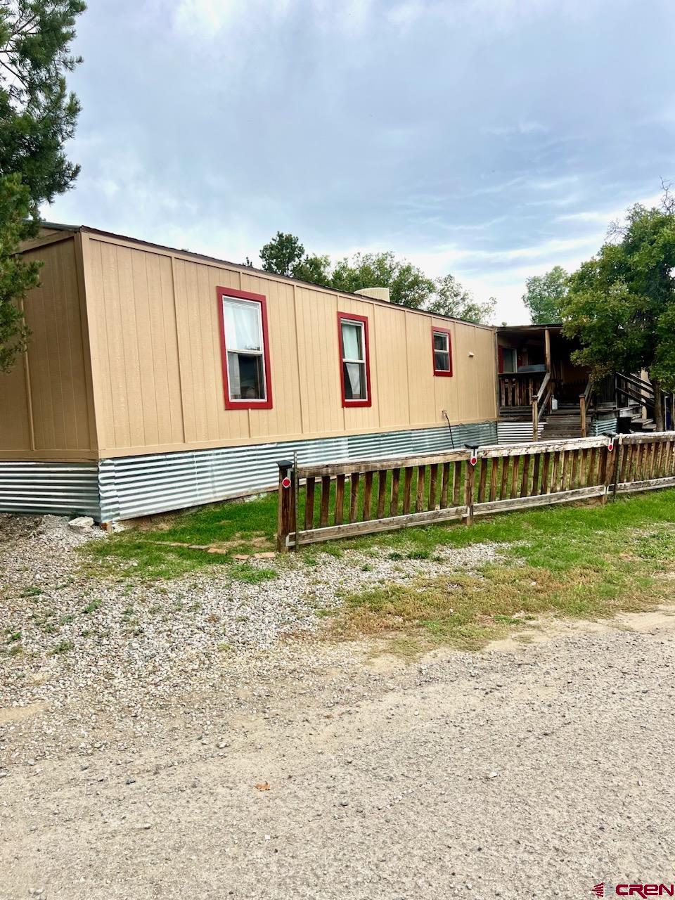 a view of a house with a backyard