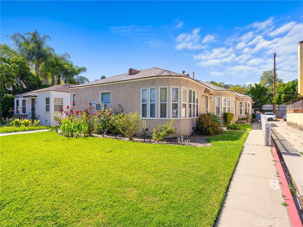 a front view of a house with garden