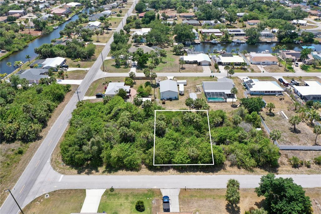 an aerial view of residential houses with outdoor space and street view