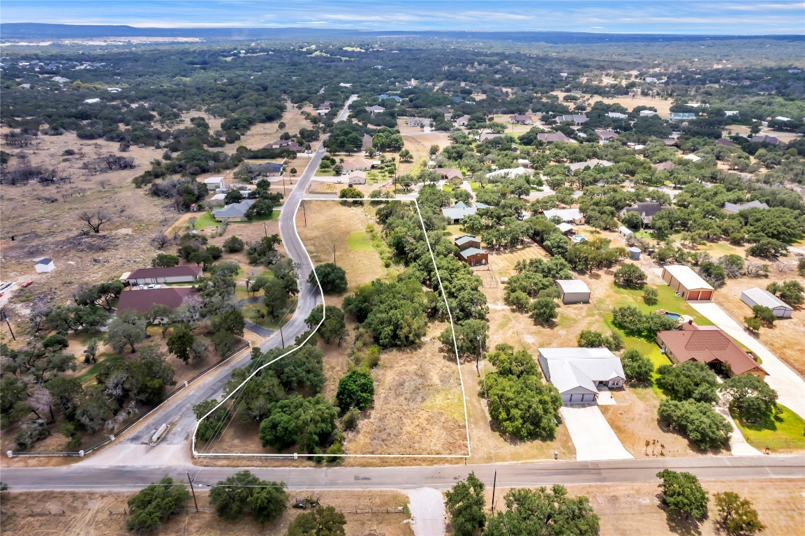 an aerial view of residential houses with city view