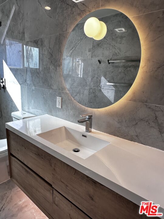 a bathroom with a sink mirror and vanity