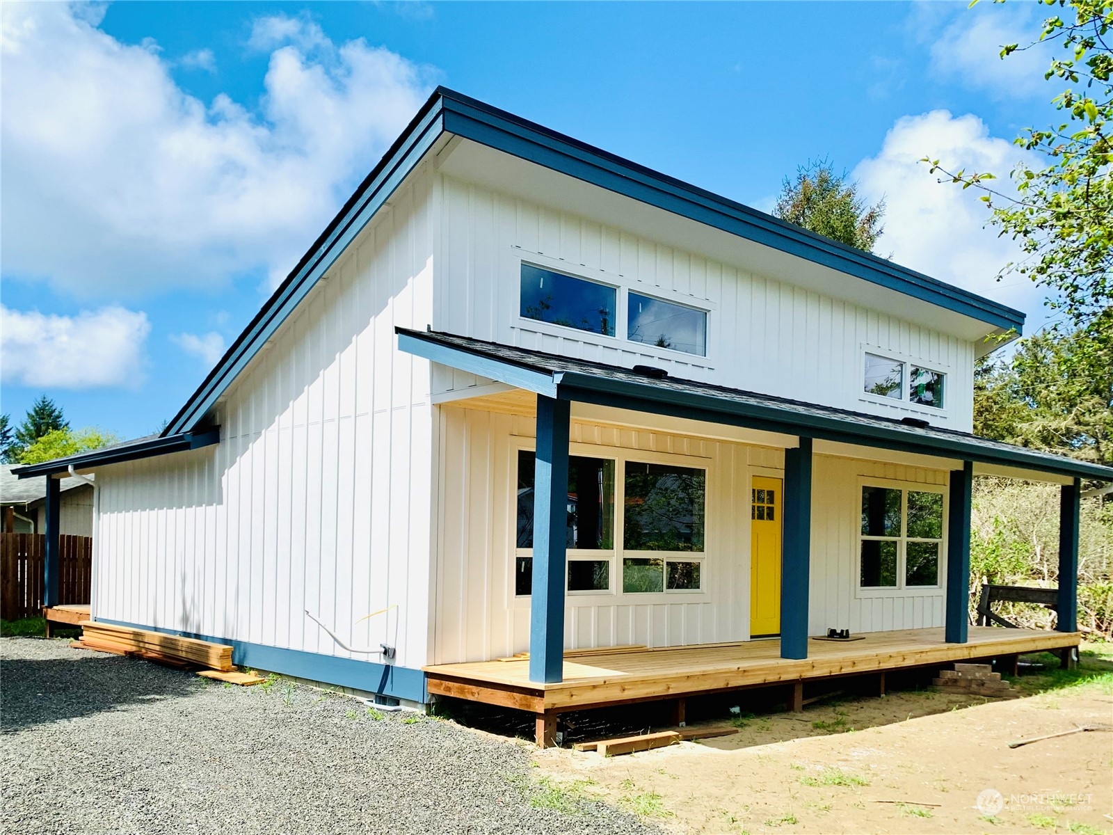 a view of a house with wooden walls and floor to ceiling window