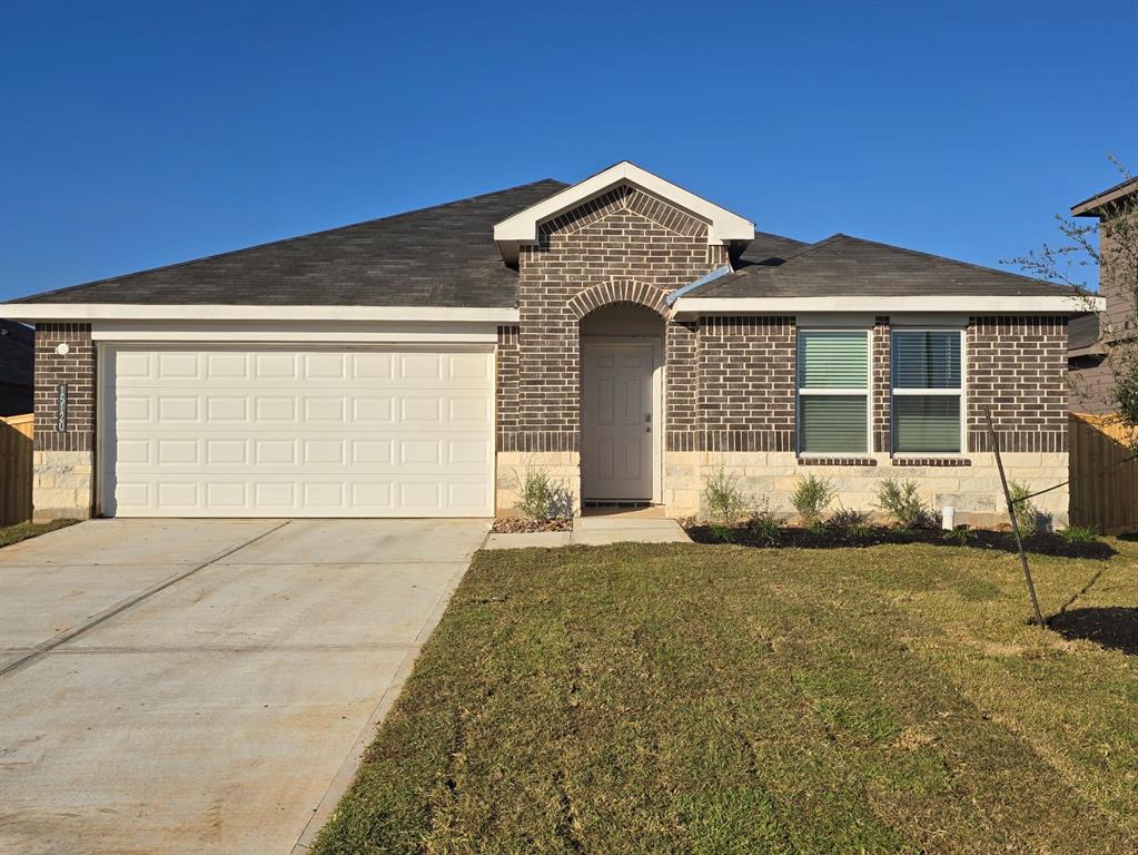 a front view of a house with a garden and yard