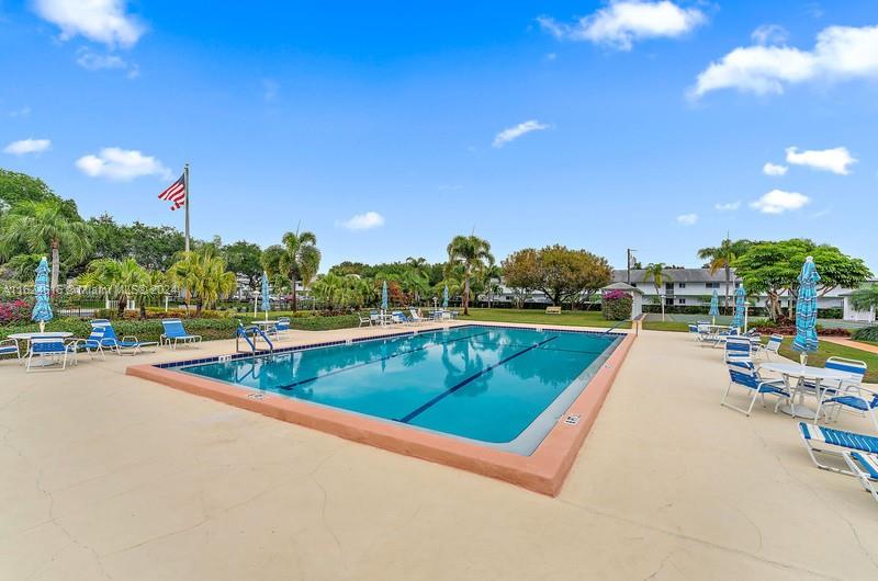 a view of a swimming pool and lounge chairs