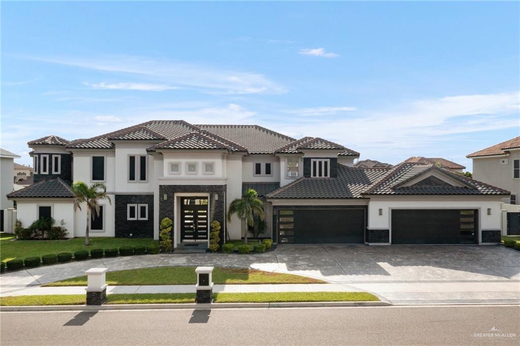 a front view of a house with a garden and yard