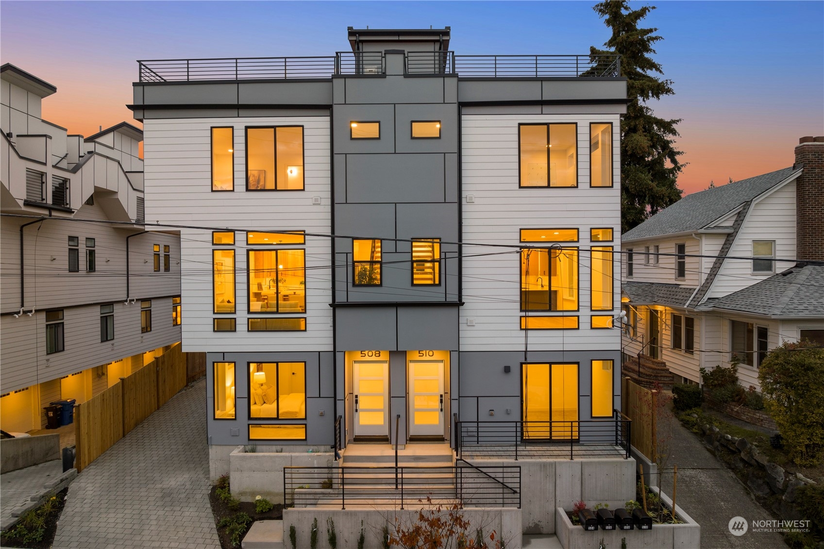 a front view of a residential apartment building with a yard