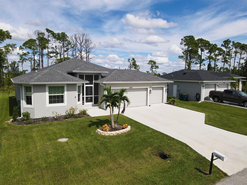 a front view of house with yard and green space