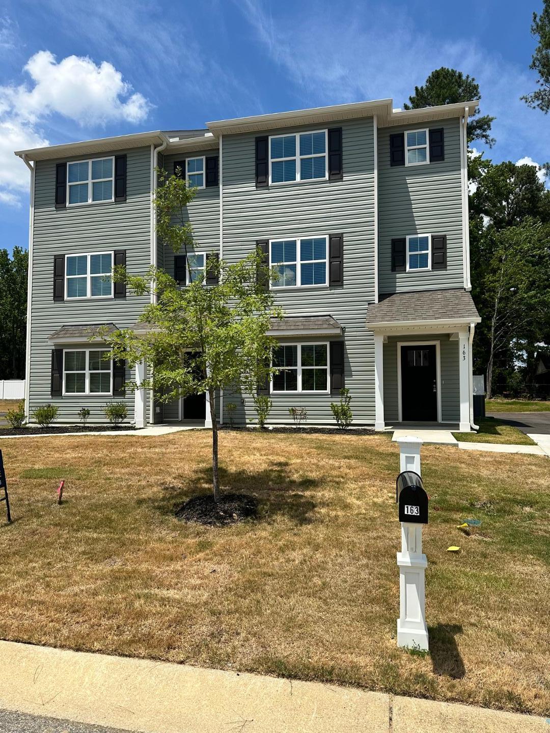 a front view of a house with a yard