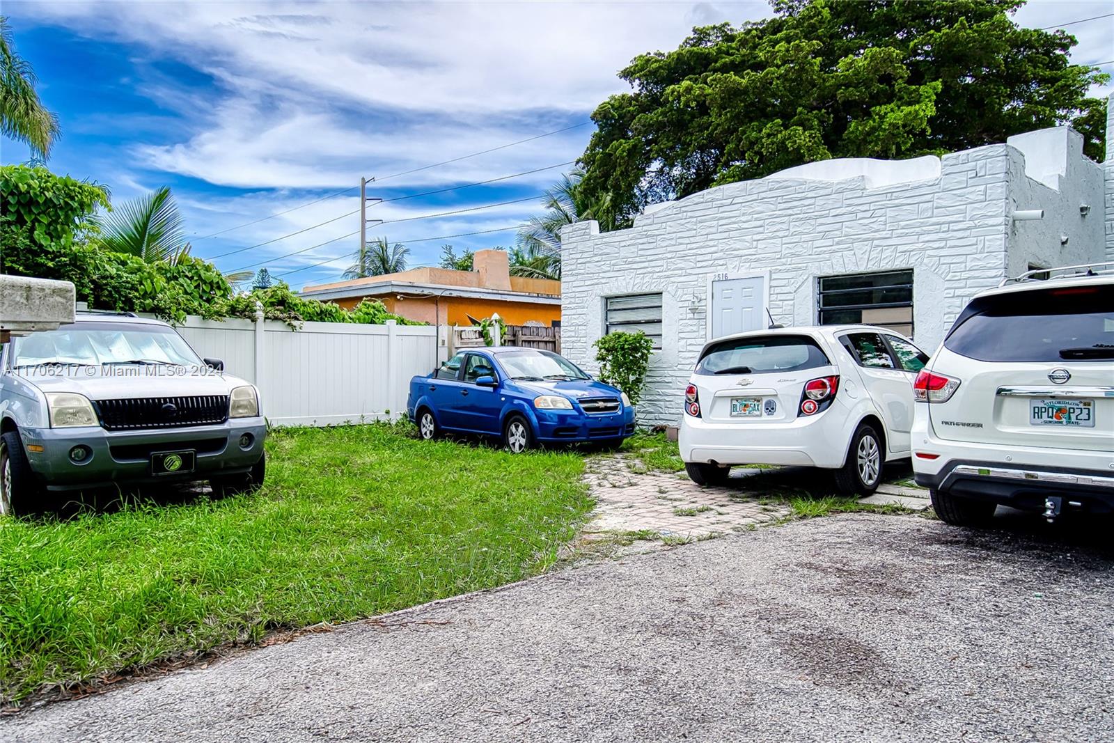 a group of cars parked in front of a house