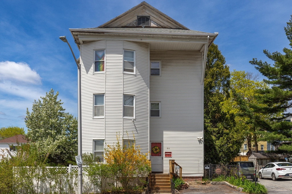 a front view of a building with trees