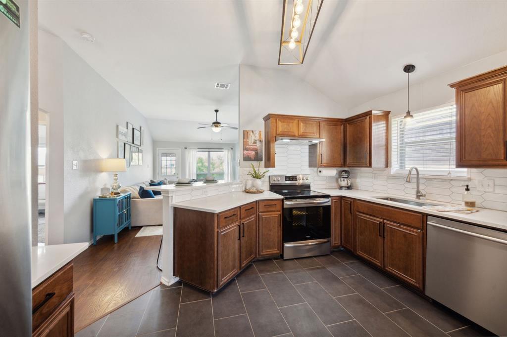 a kitchen with a sink stove and cabinets