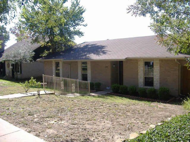 a front view of a house with a yard and porch