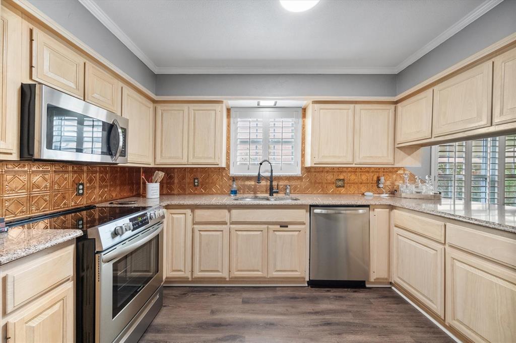 a kitchen with a sink stove top oven and cabinets